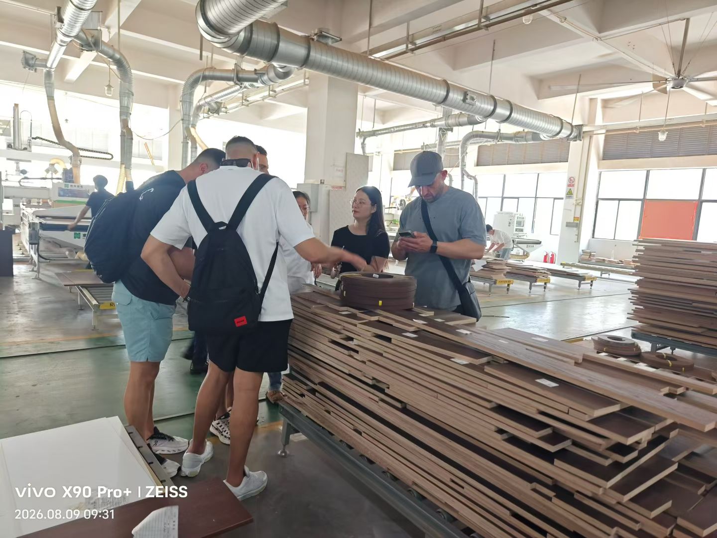 Reviewing stacks of machined timber components inside a joinery factory